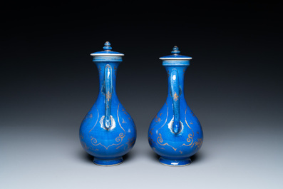 A pair of Chinese gilt-decorated powder blue-ground 'qilin' ewers and covers, Kangxi