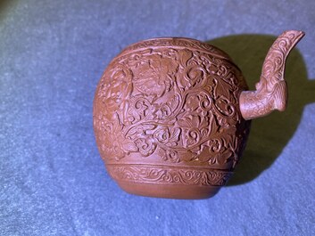 A Chinese Yixing stoneware teapot with boys among peony scrolls, Kangxi