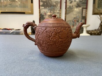 A Chinese Yixing stoneware teapot with boys among peony scrolls, Kangxi