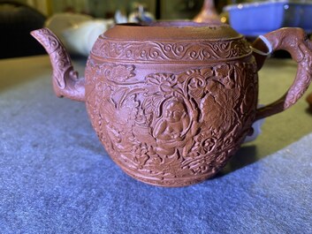 A Chinese Yixing stoneware teapot with boys among peony scrolls, Kangxi