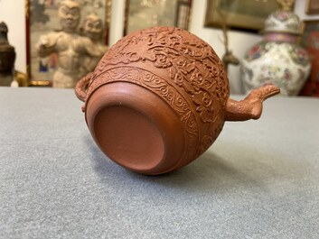 A Chinese Yixing stoneware teapot with boys among peony scrolls, Kangxi