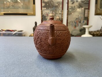 A Chinese Yixing stoneware teapot with boys among peony scrolls, Kangxi