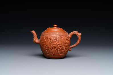 A Chinese Yixing stoneware teapot with boys among peony scrolls, Kangxi