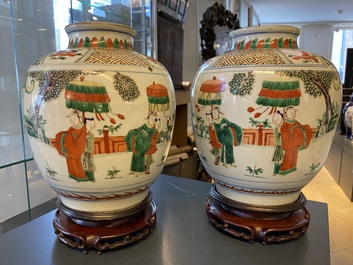 A pair of Chinese famille verte vases on wooden stands, 'hare' mark, 19th C.