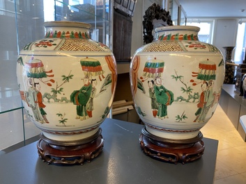 A pair of Chinese famille verte vases on wooden stands, 'hare' mark, 19th C.