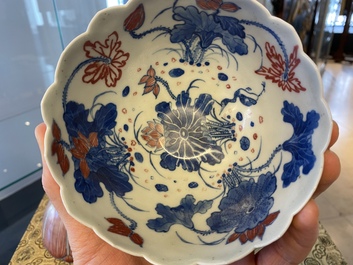 A pair of Chinese blue, white and copper-red 'lotus' bowls, Kangxi mark, 19th C.