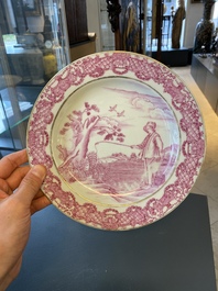 Une assiette en porcelaine de Chine &agrave; cama&iuml;eu pourpre &agrave; d&eacute;cor du 'Jeune p&ecirc;cheur' d'apr&egrave;s Abraham Bloemaert, Qianlong