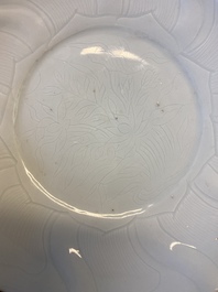 A Chinese molded white-glazed plate with incised lotus design, Xuande mark and of the period