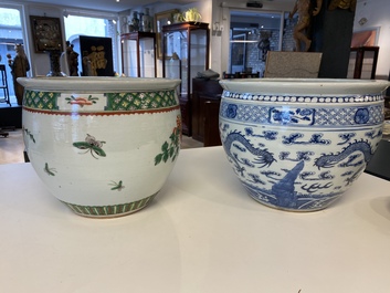 A Chinese blue and white 'dragons' fish bowl and a famille verte 'magpies' fish bowl, 19th C.