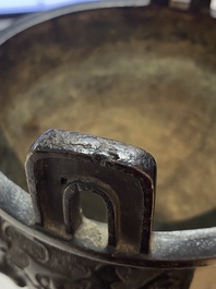 A Chinese bronze tripod censer with 'taotie' masks, Ming