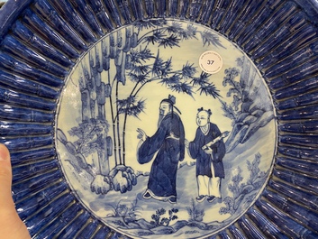 A Chinese ribbed blue and white dish with a scholar and his pupil, 19th C.