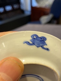 A Chinese blue and white bowl and a pair of cups and saucers, Kangxi