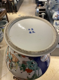 A pair of Chinese famille verte powder blue-ground vases and a fish bowl, 19th C.