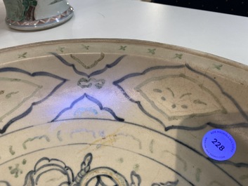 Un plat en gr&egrave;s porcelaineux d'Annam ou Vietnam &agrave; d&eacute;cor d'un lion bouddhiste en bleu, blanc, vert et dor&eacute;, 14/15&egrave;me