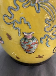 A Chinese yellow-ground famille rose rouleau vase with applied 'antiquities' design, 19th C.