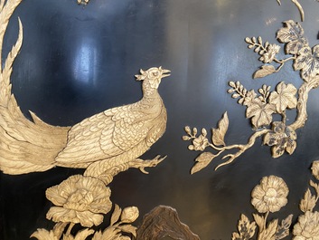 A large Japanese wooden screen with a central gilt-lacquered and ivory-inlaid panel, Meiji