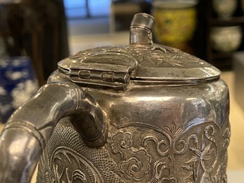 A Chinese silver teapot with birds among blossoming branches, 19th C.