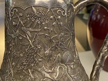 A Chinese silver teapot with birds among blossoming branches, 19th C.