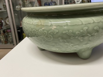 A Chinese celadon-glazed tripod censer with peony scrolls, 18/19th C.