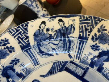 A Chinese blue and white dish with two ladies and two rabbits in a garden, Kangxi mark and of the period