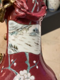 A pair of Chinese famille rose ruby-ground vases, 19th C.