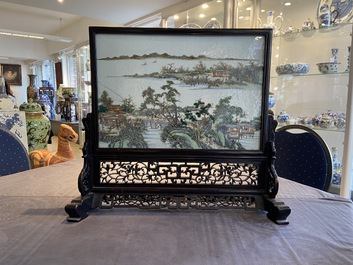 A Chinese rectangular famille rose 'landscape' plaque mounted in a wooden table screen, 19/20th C.