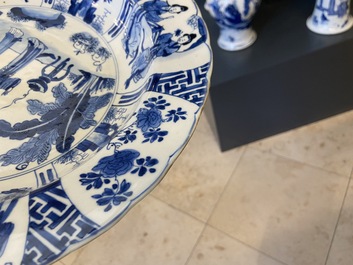 Un plat en porcelaine de Chine en bleu et blanc &agrave; d&eacute;cor de deux femmes et deux lapins dans un jardin, marque et &eacute;poque de Kangxi