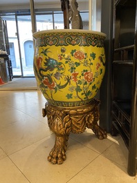 A Chinese yellow-ground famille verte 'dragons' fish bowl on gilded wooden stand, 19th C.