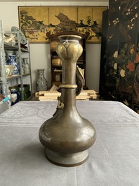 A Chinese bronze garlic-head 'hu' vase, Qianlong mark and of the period