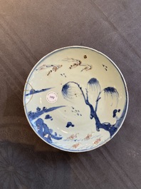 A Chinese blue, white and copper red ko-sometsuke 'fish' plate for the Japanese market, Transitional period