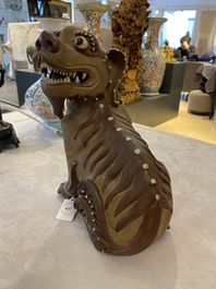 A Chinese Yixing stoneware dog on wooden stand, 19th C