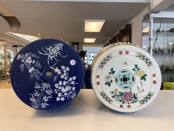 Two Chinese garden seats in famille rose and white slip-decorated blue-ground porcelain, 19th C.