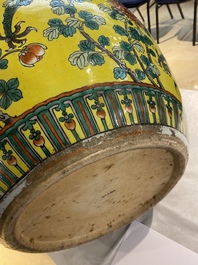 A Chinese yellow-ground famille verte 'dragons' fish bowl on gilded wooden stand, 19th C.