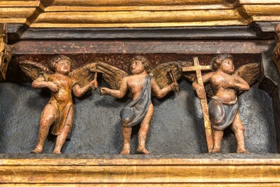 A large Flemish polychrome walnut retable, probably Ghent, dated 1529