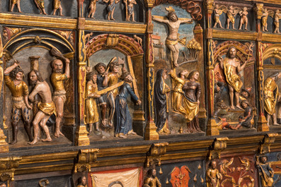 A large Flemish polychrome walnut retable, probably Ghent, dated 1529