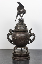 A large Japanese patinated bronze koro on stand with birds, dragons and blossoming branches, Meiji, 19th C.