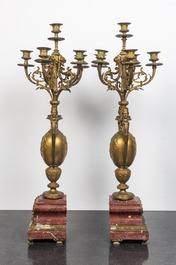 A pair of large gilt brass candelabra on red marble bases, 19th C.