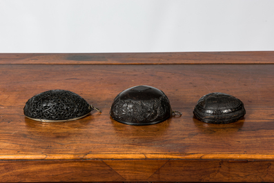 Three carved coconut pendants, French colonies, 19th C.