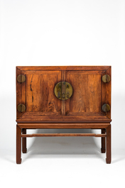 A Chinese hardwooden brass mounted two-door cabinet on foot, 20th C.