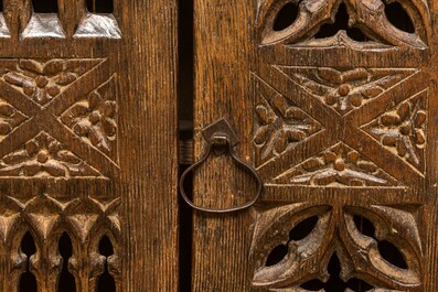 An English Gothic-style carved oak hanging cupboard composed of old elements, 17th C. and later