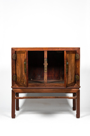 A Chinese hardwooden brass mounted two-door cabinet on foot, 20th C.