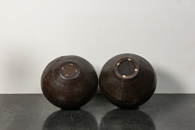 Two vases composed of riveted cast iron panels, 20th C.