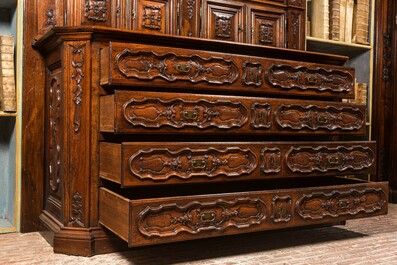 An imposing walnut sacristy cupboard with floral design and garlands, 18th C.
