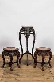 Three Chinese carved wooden stands with marble top, 19/20th C.