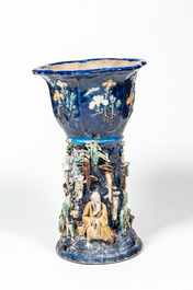 A Chinese polychrome Shiwan pottery jardini&egrave;re on stand with applied design of scholars, 19th C.