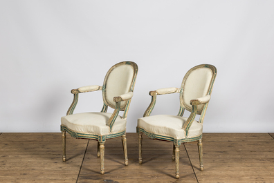 A pair of French white- and green-painted wooden armchairs, 19th C.