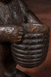 A 'Black Forest' wooden bear holding a beehive, Switzerland, 19th C.