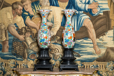 A pair of large Japanese porcelain vases on ebonised wooden stands, 19th C.