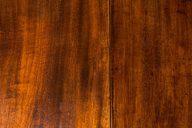 An oval English mahogany drop leaf table, 19th C.