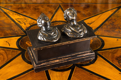 A pair of Italian patinated bronze miniature busts mounted on a later ebonised wooden stand, 17th C.
